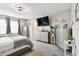 Serene main bedroom with modern decor, features a television, and comfortable carpet at 12643 Horseshoe Bend Dr, Lithia, FL 33547