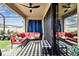 Relaxing screened patio with stylish seating, black and white rug, and ceiling fans for outdoor comfort at 12643 Horseshoe Bend Dr, Lithia, FL 33547