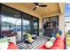 Cozy covered patio boasts stylish seating, a black and white rug, and views of the backyard at 12643 Horseshoe Bend Dr, Lithia, FL 33547