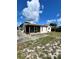 Wide backyard view featuring a screened-in porch and ample yard space at 1332 Fuchsia Dr, Holiday, FL 34691