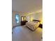 Well-lit bedroom with carpeting, a window, and dresser with mirrors at 1332 Fuchsia Dr, Holiday, FL 34691