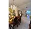 Formal dining room with chandelier, wood table, and chairs adjoining the living room, perfect for gatherings at 1332 Fuchsia Dr, Holiday, FL 34691