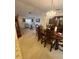 Open-concept dining and living area, illuminated by a chandelier, offering a spacious area for entertaining at 1332 Fuchsia Dr, Holiday, FL 34691