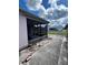 Exterior side view of the property showing the screened-in porch and yard at 1332 Fuchsia Dr, Holiday, FL 34691