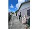 Exterior side view of the property showing the side yard and utilities at 1332 Fuchsia Dr, Holiday, FL 34691