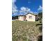 Backyard view of the house, featuring the exterior with a lawn at 1332 Fuchsia Dr, Holiday, FL 34691