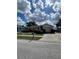 Charming single-story home featuring a well-maintained lawn, an attached garage and inviting curb appeal at 1332 Fuchsia Dr, Holiday, FL 34691