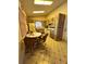 Cozy eat-in kitchen featuring a breakfast nook, wood cabinets and tile floors, creating a warm ambiance at 1332 Fuchsia Dr, Holiday, FL 34691