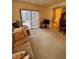 Carpeted living room featuring a sofa and sliding glass doors at 1332 Fuchsia Dr, Holiday, FL 34691