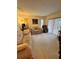 Spacious living room with neutral carpeting and sliding glass door to the outside at 1332 Fuchsia Dr, Holiday, FL 34691