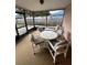 Enclosed porch featuring a table and chairs, great for relaxing and entertaining guests at 1332 Fuchsia Dr, Holiday, FL 34691