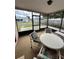 Enclosed porch featuring a table and chairs, great for relaxing and entertaining guests at 1332 Fuchsia Dr, Holiday, FL 34691