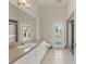 Bright bathroom featuring dual sinks, a walk-in shower, and access to a pool area at 13375 Newcastle Ave, Spring Hill, FL 34609