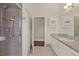 Bathroom featuring a tiled shower, spacious vanity and a closet at 13375 Newcastle Ave, Spring Hill, FL 34609