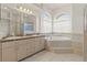 Spacious ensuite bathroom includes double sinks, a soaking tub, and a separate tiled shower at 13375 Newcastle Ave, Spring Hill, FL 34609