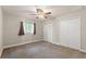 Neutral bedroom with carpet flooring, dual closets, and natural light at 13375 Newcastle Ave, Spring Hill, FL 34609