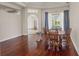 Bright dining room featuring hardwood floors, a wood dining table, and natural light through the window at 13375 Newcastle Ave, Spring Hill, FL 34609