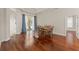 Elegant dining room showcasing hardwood floors, a round wood table, and access to the outdoor patio at 13375 Newcastle Ave, Spring Hill, FL 34609