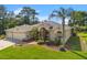Attractive one-story home with a three-car garage, lush landscaping, and a well-manicured lawn at 13375 Newcastle Ave, Spring Hill, FL 34609
