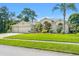 Well-maintained house with a lawn, landscaping, and a three-car garage at 13375 Newcastle Ave, Spring Hill, FL 34609