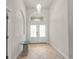 Bright foyer features tiled floor, arched window over the entry doors, and chandelier at 13375 Newcastle Ave, Spring Hill, FL 34609