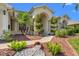 Close-up of home showcasing its arched entryway, meticulously trimmed shrubs, and decorative rock landscaping at 13375 Newcastle Ave, Spring Hill, FL 34609