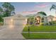 Charming single-story home with a well-maintained lawn, manicured landscaping, and a three-car garage at 13375 Newcastle Ave, Spring Hill, FL 34609