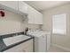 Bright laundry room features a sink, window, and modern appliances at 13375 Newcastle Ave, Spring Hill, FL 34609