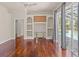 Living room with hardwood floors, built-in shelves, and pool view at 13375 Newcastle Ave, Spring Hill, FL 34609
