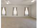 Spacious living room with multiple windows providing natural light and neutral tones at 13375 Newcastle Ave, Spring Hill, FL 34609