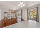 Elegant living room with hardwood floors, built-in shelving, and sliding doors to the pool area at 13375 Newcastle Ave, Spring Hill, FL 34609