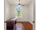 Stylish home office featuring a hardwood floor, ceiling fan, a large window, and lots of workspace at 13375 Newcastle Ave, Spring Hill, FL 34609