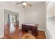 Home office featuring hardwood floors, a ceiling fan, a large window, and a doorway to the dining room at 13375 Newcastle Ave, Spring Hill, FL 34609