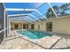 Outdoor pool area surrounded by a screened-in patio at 13375 Newcastle Ave, Spring Hill, FL 34609