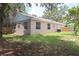 Back exterior with a fenced yard and lush lawn at 1344 S Michigan Ave, Clearwater, FL 33756