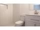 Updated bathroom features modern vanity, decorative white tiles, and shower at 1344 S Michigan Ave, Clearwater, FL 33756