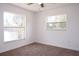 This carpeted bedroom has a ceiling fan and two windows at 1344 S Michigan Ave, Clearwater, FL 33756