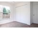 Carpeted bedroom with a closet, a window, and base molding at 1344 S Michigan Ave, Clearwater, FL 33756