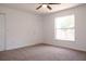 Neutral bedroom with carpet flooring and a large window allowing ample natural light at 1344 S Michigan Ave, Clearwater, FL 33756