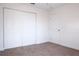 This carpeted bedroom has a double closet and a ceiling fan at 1344 S Michigan Ave, Clearwater, FL 33756