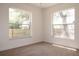 Bedroom featuring natural light from two windows and neutral carpeting at 1344 S Michigan Ave, Clearwater, FL 33756