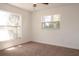 Bright bedroom with carpet flooring, two windows, and fresh, neutral paint at 1344 S Michigan Ave, Clearwater, FL 33756