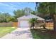Charming home featuring a well-maintained lawn, and a driveway leading up to a two-car garage at 1344 S Michigan Ave, Clearwater, FL 33756
