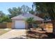 Charming single-story home featuring a one-car garage, well-maintained lawn, and tropical landscaping at 1344 S Michigan Ave, Clearwater, FL 33756