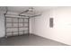 View of a clean garage with a white door, light grey floor and a door opening mechanism at 1344 S Michigan Ave, Clearwater, FL 33756