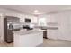 Well-lit kitchen featuring stainless steel appliances, granite countertops, white cabinets, and an island at 1344 S Michigan Ave, Clearwater, FL 33756