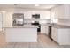 Spacious kitchen with white cabinetry, granite countertops, stainless steel appliances and a kitchen island at 1344 S Michigan Ave, Clearwater, FL 33756