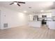 Open-concept living space with new wood flooring connecting to an updated kitchen with stainless steel appliances at 1344 S Michigan Ave, Clearwater, FL 33756