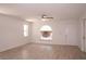 Bright living room featuring new wood floors, a ceiling fan, and a large arched window at 1344 S Michigan Ave, Clearwater, FL 33756