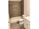 Modern bathroom with new tub, tiled walls, updated vanity and new fixtures at 1427 15Th S St, St Petersburg, FL 33705